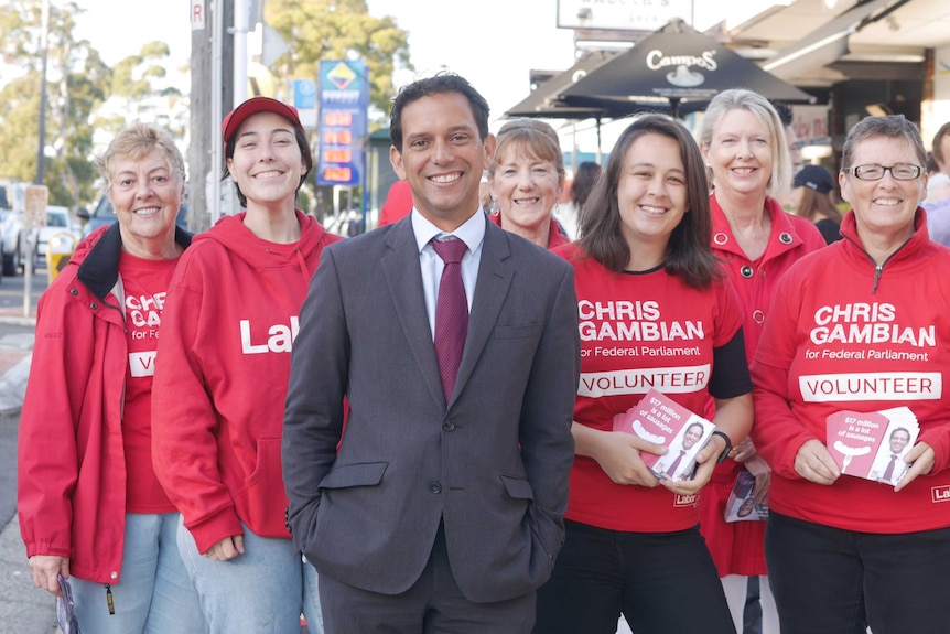 The Labor candidate for the seat of Banks in New South Wales poses for a photo with some of his volunteers.