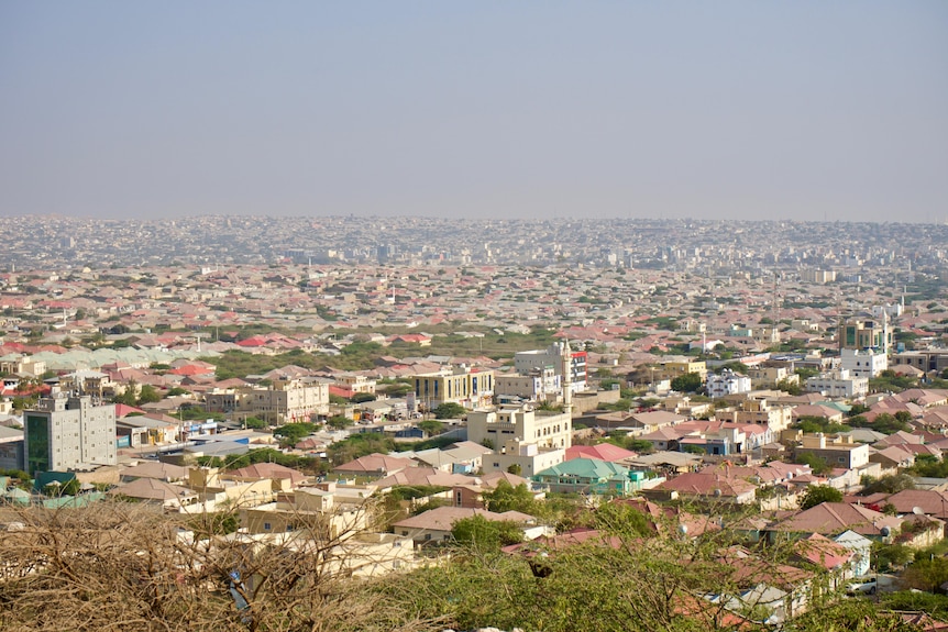 View of the red and cream buildings of a city with lots of blue sky