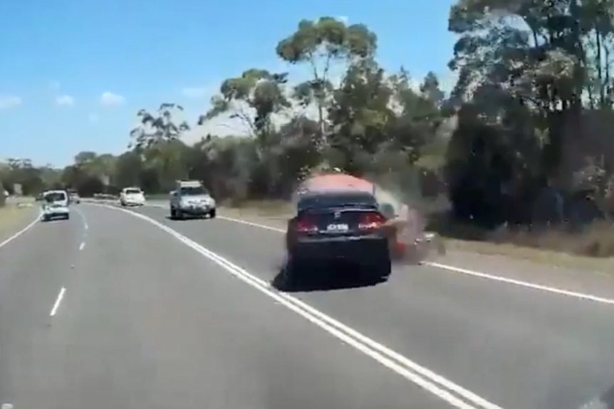 A car colliding with another car on the wrong side of the road