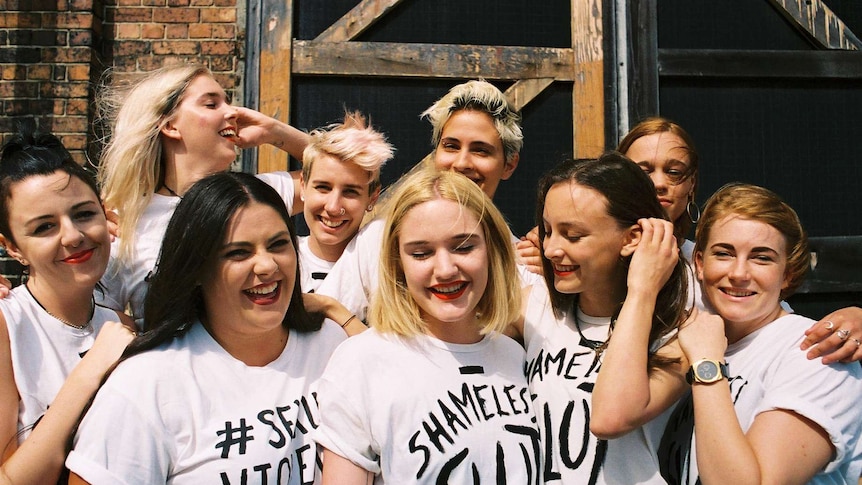 Women members of the 'Sexual Violence Won't Be Silenced' (SVWBS) group pose in white campaign t-shirts.