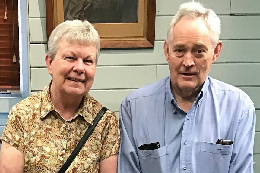 A man and woman smile for the camera.