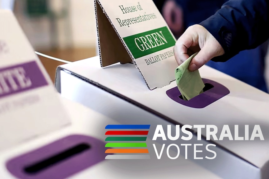 Close up of a hand dropping a green House of Representatives voting paper into a ballot box