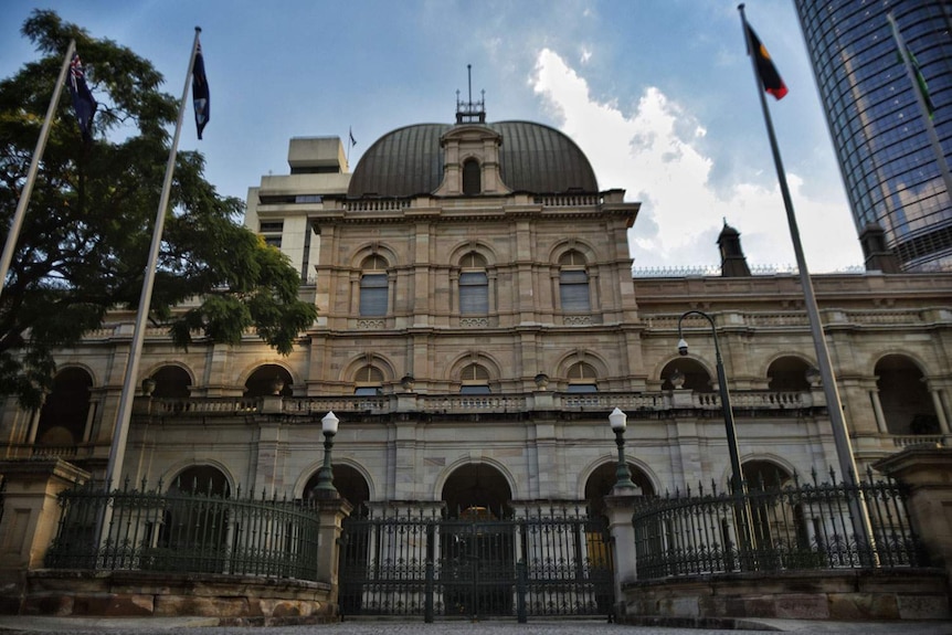 Front of Parliament House main entrance and flagpoles with Executive Annexe in background in Brisbane.