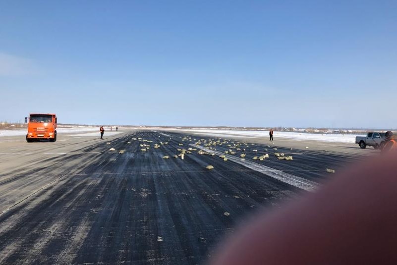 Gold bars litter an airport runway