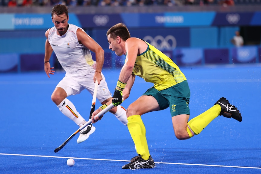 Eddie Ockenden running with hockey stick in hand during a game