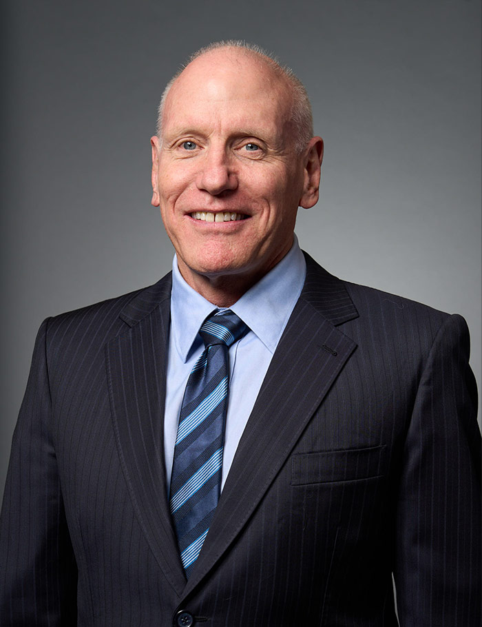 bald man in suit and tie