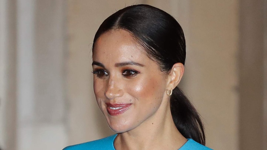 Meghan Markle appears in a blue dress