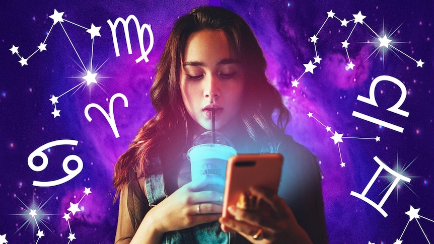 Woman sipping on ice coffee and reading phone with star signs symbols around her