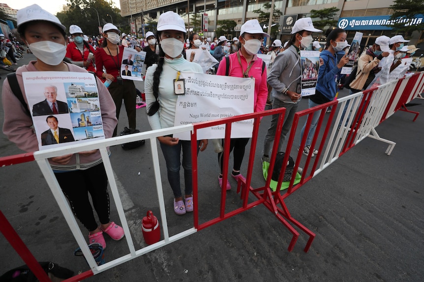 Women in masks hold signs at strike