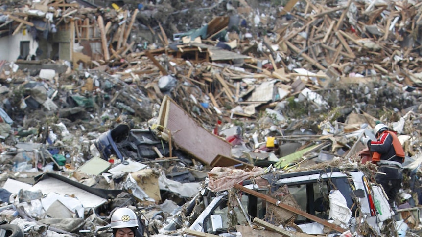 Rescue workers lift a victim from the rubble