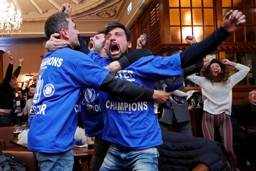 Leicester City fans celebrate a goal in a pub in Leicester.