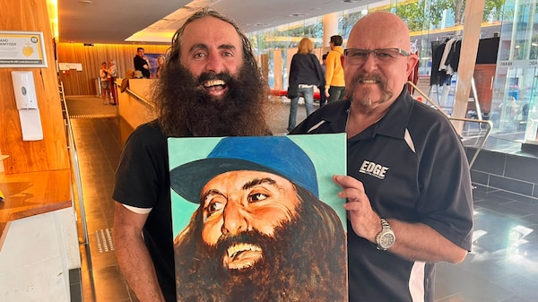 Costa and artist holding a painting of Costa for The Bradley Awards 2024.