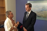 Tasmanian Health Minister Michael Ferguson talking to a patient