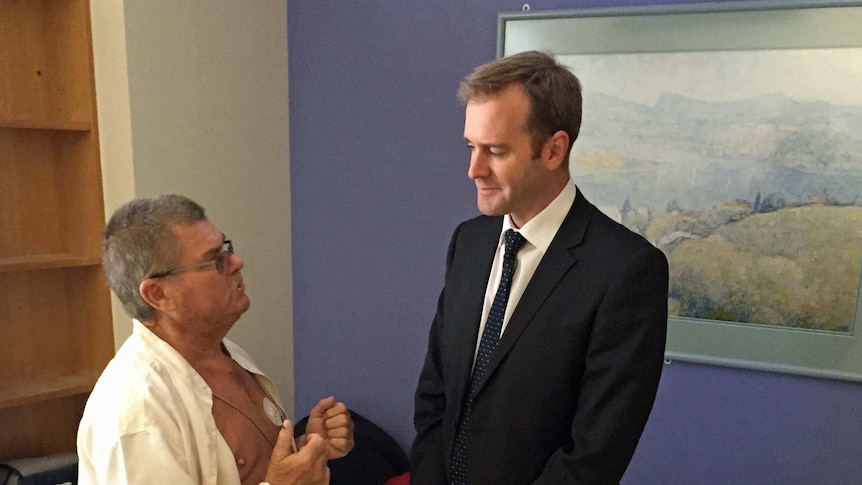 Tasmanian Health Minister Michael Ferguson talks to a patient at the Royal Hobart Hospital.