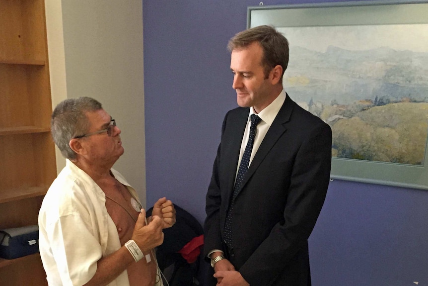 Tasmanian Health Minister Michael Ferguson talks to a patient at the Royal Hobart Hospital.