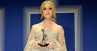 Jessica Marais holds her Silver Logie for Best Actress with both hands as she poses in the green room.