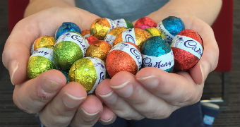 Woman holds handful of Easter eggs