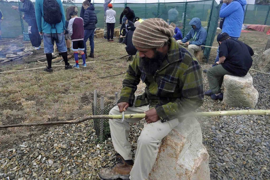 A Tasmanian Aboriginal man makes a spear