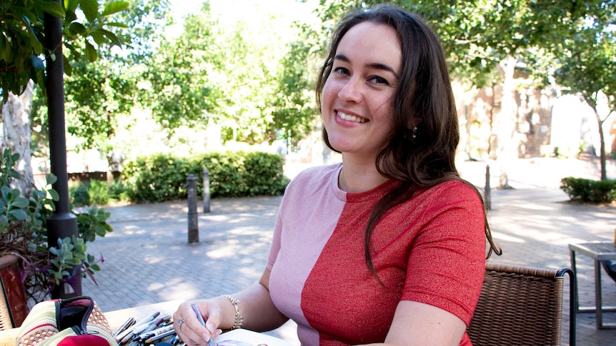 Jess Harwood sitting outside, in a story about painful, heavy periods and adenomyosis.