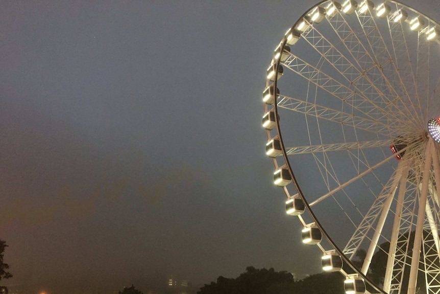 Eye of Brisbane with a foggy Brisbane city behind it