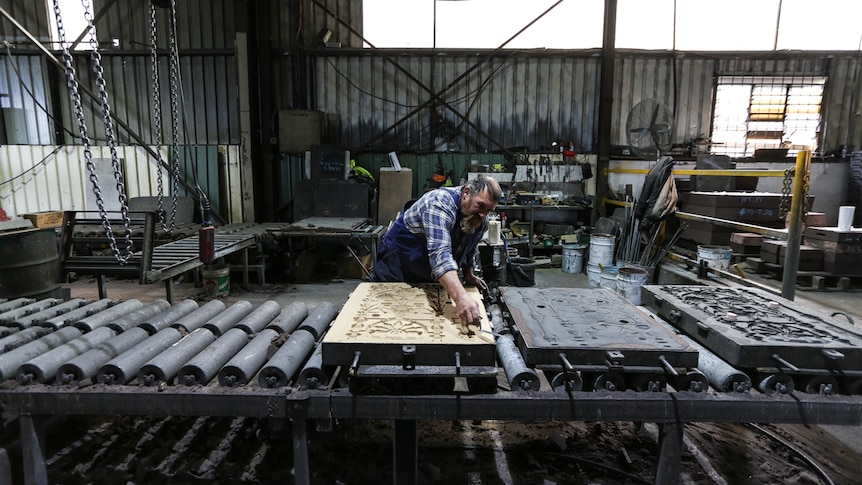 Moulder Malcolm Sturgess finishing off a sand mould, started work at Billman's in 1989.