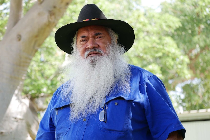 Senator Dodson stands next to a tree near the Broome court house.