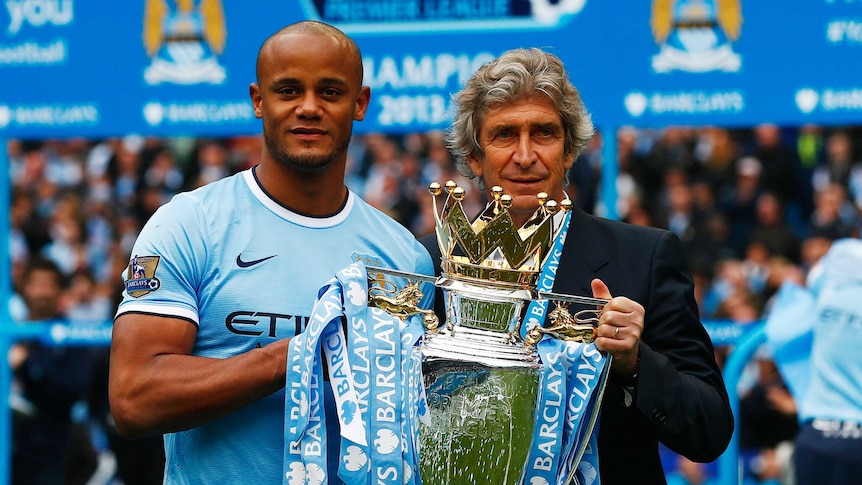Manchester City captain and manager hold the trophy