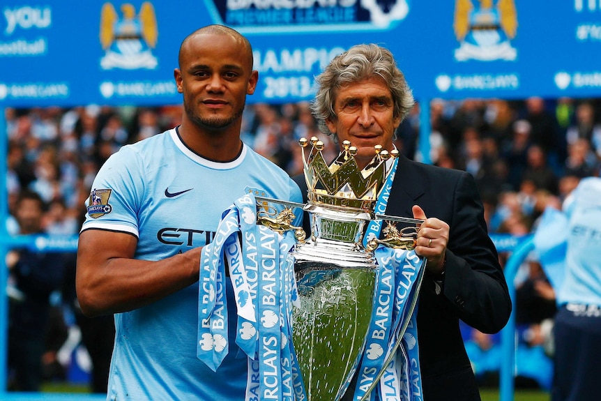 Manchester City captain and manager hold the trophy