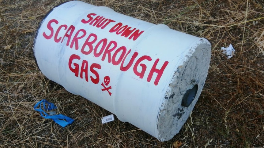 A concrete drum with spray paint on it.