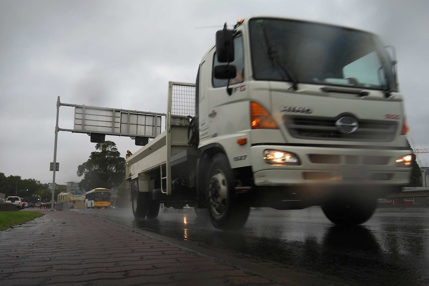 Truck driving in wet weather.