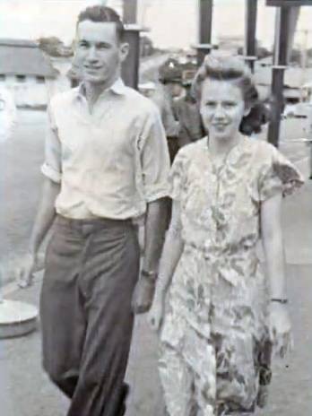 An old photo of a couple in 1945 walking down the street