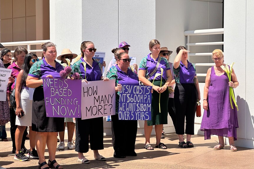 a group of women wearing purple