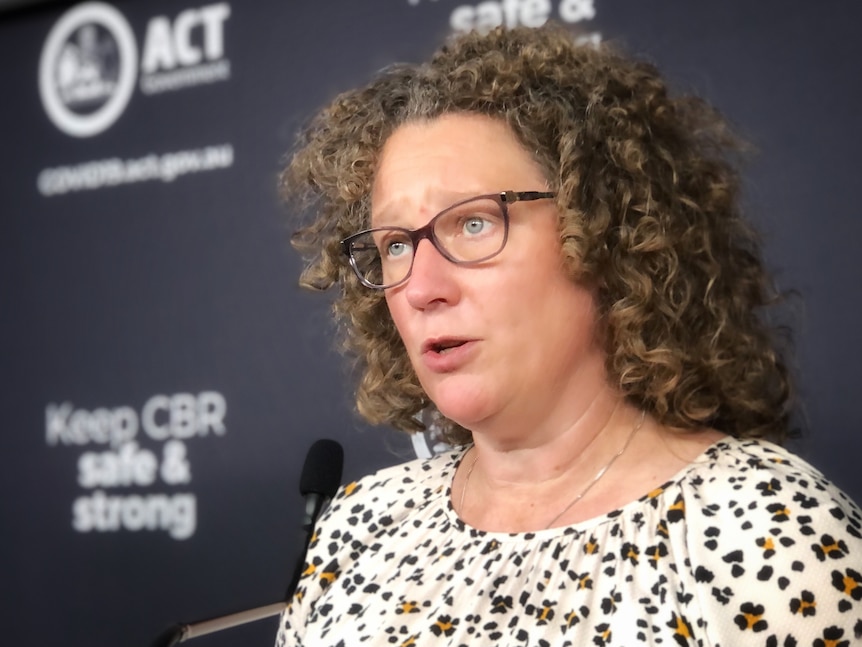 Kerryn Coleman looks serious while speaking at a press conference.