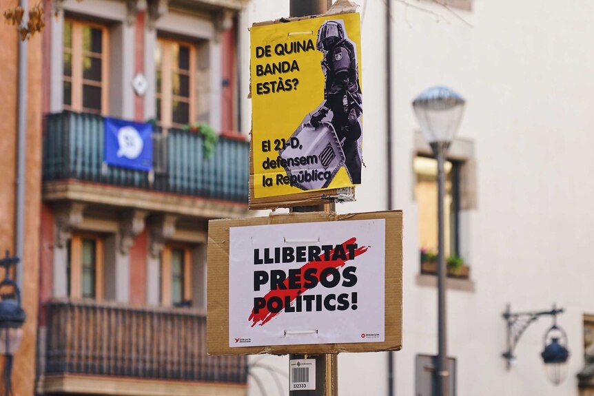 Election posters on a light pole in Barcelona ahead of the Catalan regional election.