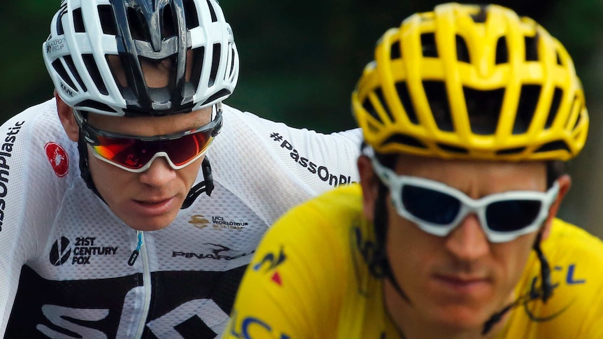 Chris Froome in white rides behind Geraint Thomas in yellow.