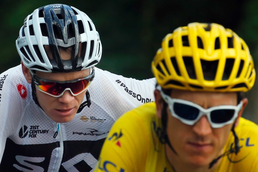 Chris Froome in white rides behind Geraint Thomas in yellow.