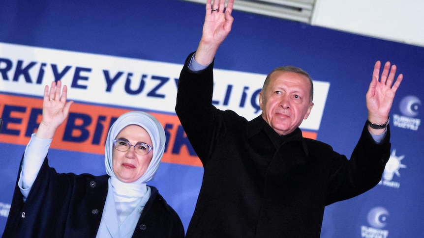 Turkish President Tayyip Erdogan, accompanied by his wife Ermine Erdogan, greets supporters.