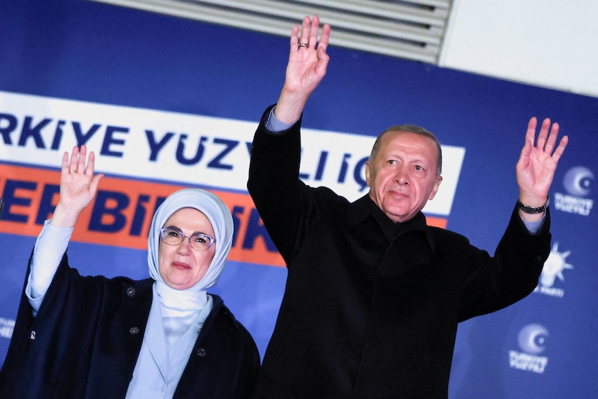 Turkish President Tayyip Erdogan, accompanied by his wife Ermine Erdogan, greets supporters.