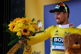 Peter Sagan, wearing the Tour de France leader's yellow jersey, celebrates after stage two, 2018.