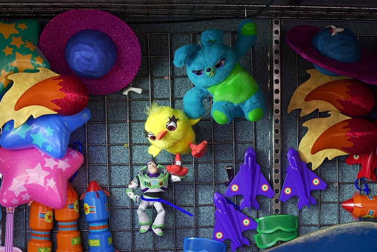 Colour still of stuffed toys Ducky and Bunny rescuing Buzz Lightyear from carnival prize display in 2019 film Toy Story 4.