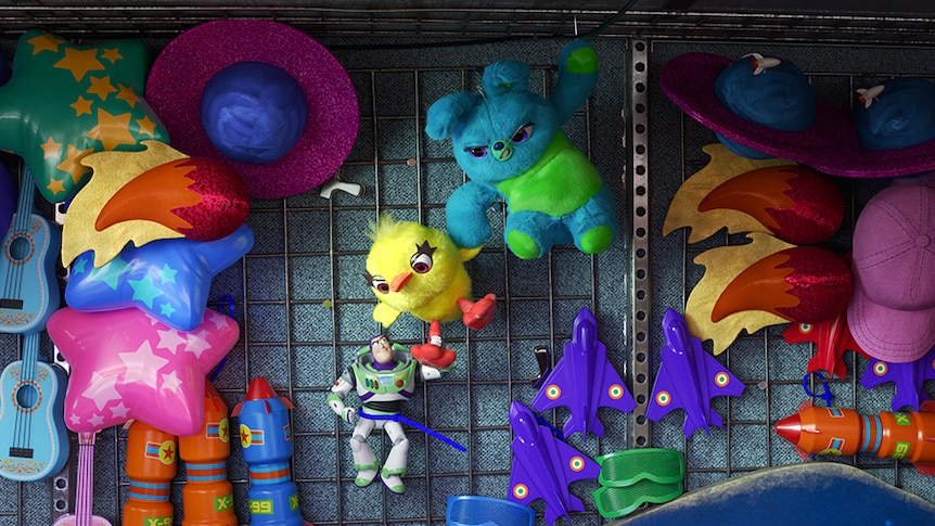 Colour still of stuffed toys Ducky and Bunny rescuing Buzz Lightyear from carnival prize display in 2019 film Toy Story 4.