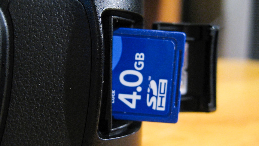 A memory card is inserted into a camera.