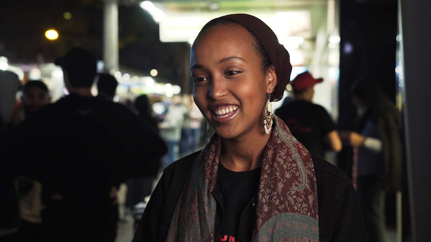 Sumaya Barud smiling on scene of the Ramadan night market in Lakemba, in Sydney's west.