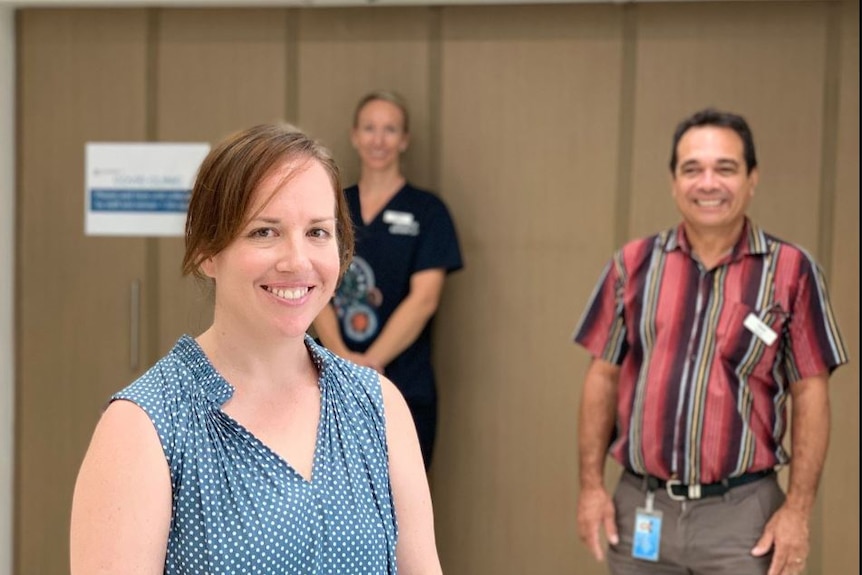 Dr Pippa May smiles, with staff in the background