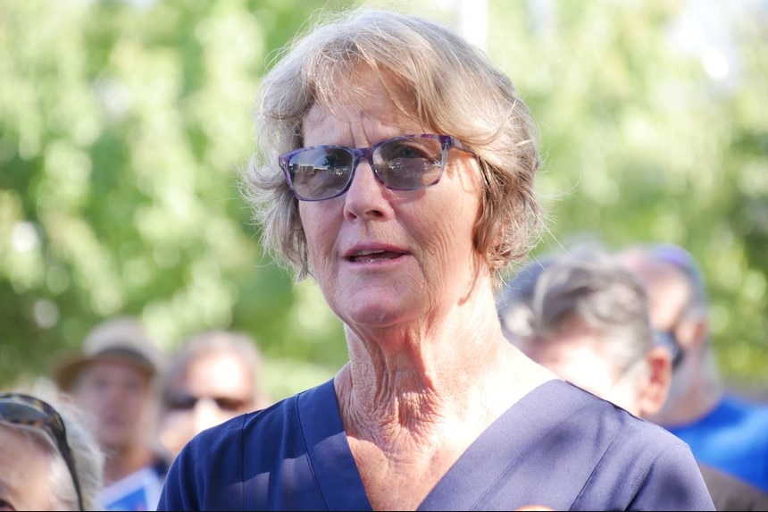 A close up of a woman wearing sunglasses.