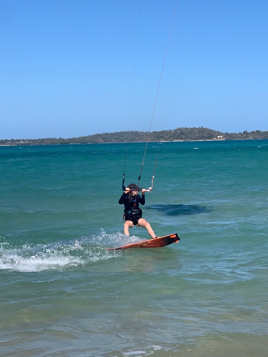 Gove 13-year-old Indi Young riding a kiteboard on the ocean.