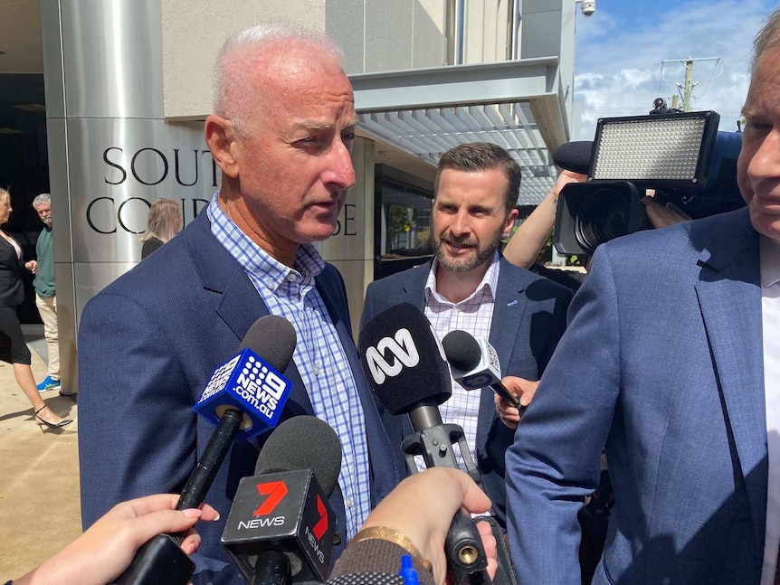 A man speaks to the media out the front of the Southport Magistrates Court