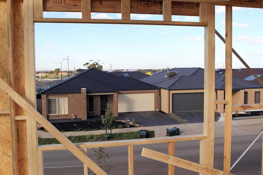 View of a house through another house under construction.