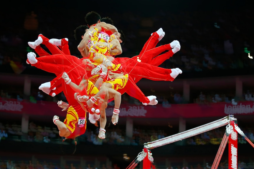 Flurry of action: Zou Kai competes in the horizontal bar. China claimed gold in the men's team final.