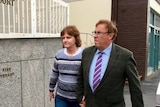 Stuart Slade and his wife enter Hobart Magistrates Court